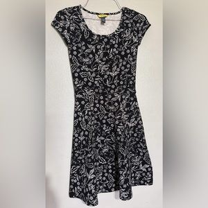 Cute woman black short dress with white floral